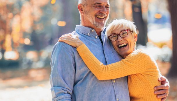 Active seniors on a walk in autumn forest